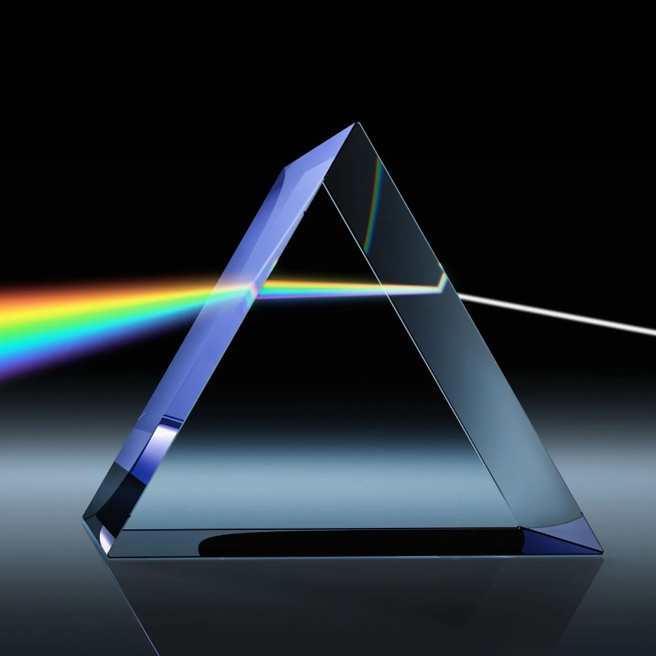 A glass prism splitting a beam of white light into a rainbow